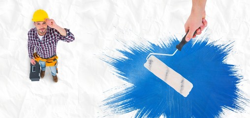 Poster - Composite image of handyman holding paint roller
