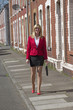 © petert2 - Businesswoman carrying briefcase along a residential street