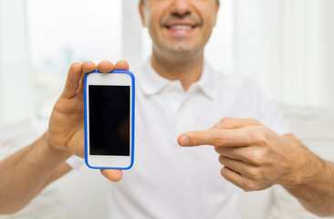 Canvas Print - close up of happy man with smartphone at home