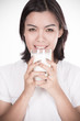 © Nonwarit - Laughing young woman with a glass of milk