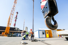Crane Hook With Workers In The Background