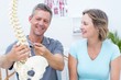© WavebreakmediaMicro - Physiotherapist showing spine model to his patient