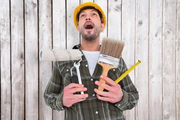 Poster - Composite image of screaming manual worker holding various tools