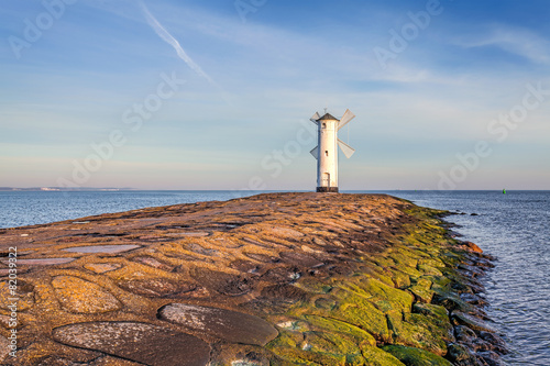 Naklejka na szybę Vivid sunrise over pier and lighthouse in Swinoujscie.