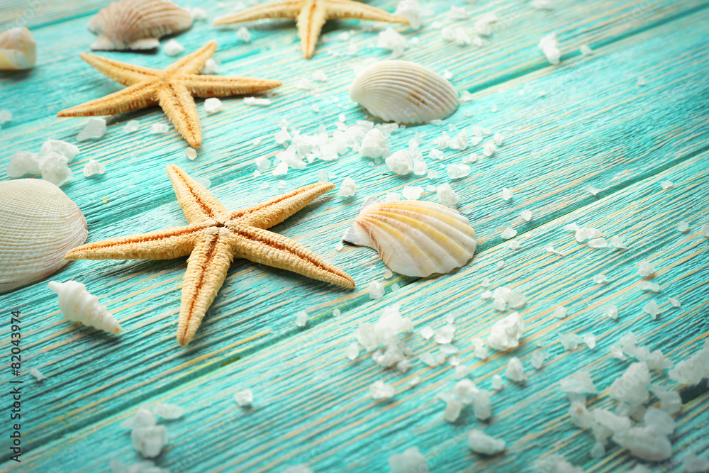 Sea stars and shells on wooden background