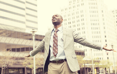 man celebrates freedom success arms raised looking up