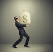 © ArtFamily - man holding big bag with money