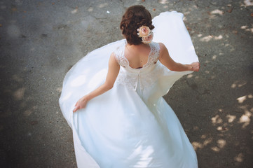 beautiful bride standing back in her wedding dresss