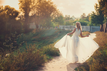 Beautiful bride standing back in her wedding dresss