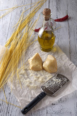 Wall Mural - Grated parmesan cheese, bottle of olive oil and metal grater on