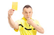 Football referee showing a yellow card