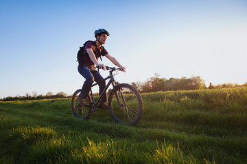 Wall Mural - outdoor sport, young man riding bicycle in the nature