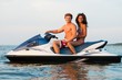 © Nejron Photo - Multinational couple sitting on a jet ski
