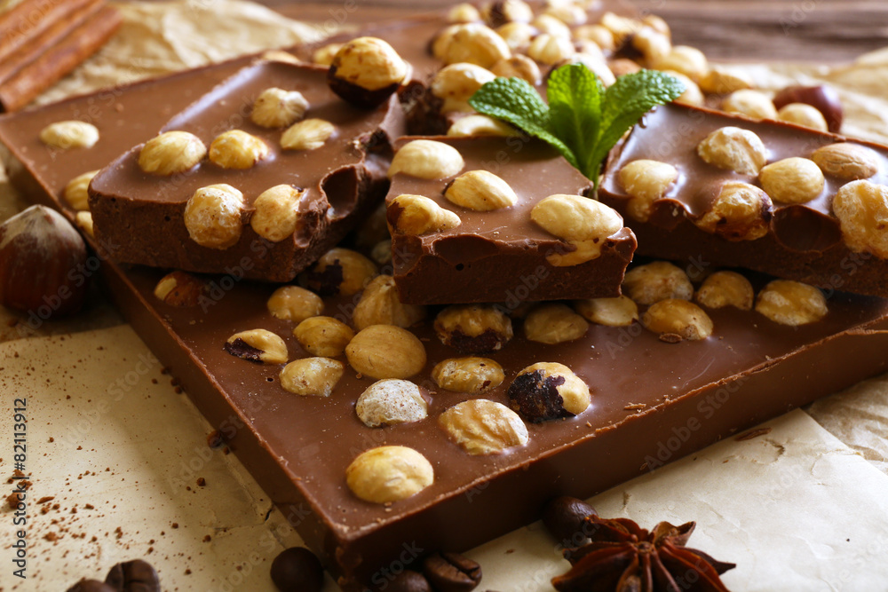 Delicious chocolates with spices on table, closeup
