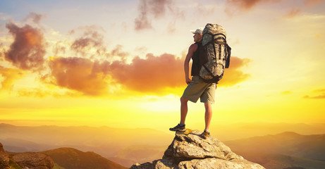 Wall Mural - tourist on high rocks. sport and active life concept