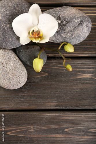 Naklejka - mata magnetyczna na lodówkę Spa stones and orchid flower on wooden background