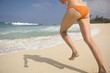 © PBNJ Productions/Blend Images - Caucasian woman running in bikini on beach