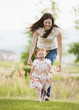 © Mike Kemp/Blend Images - Caucasian mother and daughter playing outdoors