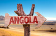 Angola wooden sign with desertic road background