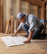 © Tanya Constantine/Blend Images - Hispanic construction worker looking at blueprints