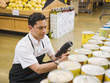 © Erik Isakson/Blend Images - Hispanic worker scanning items in grocery store
