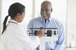 © JGI/Tom Grill/Blend Images - Black doctor weighing patient