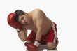 © Granger Wootz/Blend Images - Overweight boxer kneeling on floor