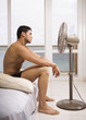 © PBNJ Productions/Blend Images - Hispanic man sitting in front of fan