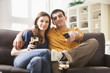 © Mike Kemp/Blend Images - Couple watching television on sofa