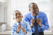 © Mike Kemp/Blend Images - Father and son straightening their ties