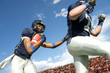 © Pete Saloutos/Blend Images - Football players passing ball