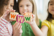 © JGI/Jamie Grill/Blend Images - Girls holding colorful 'w' blocks
