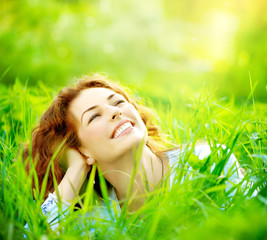 Wall Mural - beautiful young woman outdoors enjoying nature