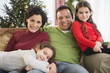 © JGI/Jamie Grill/Blend Images - Family relaxing together on sofa