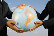 © Visual Ideas/Camilo Morales/Blend Images - African businesspeople holding globe