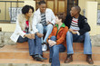 © Karin Dreyer/Blend Images - Multi-ethnic couples sitting on porch steps