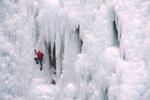 Caucasian Man Climbing Ice Wall