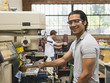 © Erik Isakson/Blend Images - Workers using machinery in machine shop