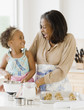 © JGI/Jamie Grill/Blend Images - African grandmother baking cookies with granddaughter