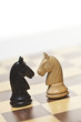 © Walter Zerla/Blend Images - Close up of knight chess pieces