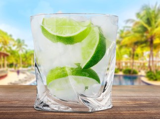 Sticker - Gin. Cocktail with ice and lime slice isolated on white