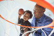© Mike Kemp/Blend Images - Father and son playing basketball together