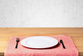 Wall Mural - Plate. Empty plate with fork and knife on wooden table. Table