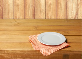 Wall Mural - Plate. Empty white plate on wooden table over red grunge