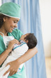 © JGI/Tom Grill/Blend Images - Hispanic doctor holding newborn in hospital