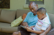 © Inti St Clair/Blend Images - African American father and son using digital tablet