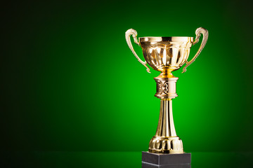 Wall Mural - gold cup trophy on green background