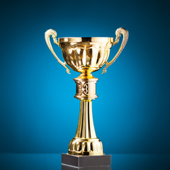 Wall Mural - gold cup trophy on blue background