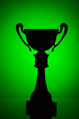 Wall Mural - cup trophy silhouette on green background