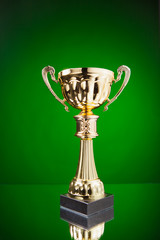 Wall Mural - gold cup trophy on green background
